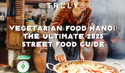 Truly Voyage blog post graphic titled "Vegetarian Food Hanoi: The Ultimate 2026 Street Food Guide" showing a smiling local vendor cooking at a street stall with large clay pots in the background.
