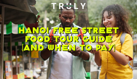 thumbnail for hanoi free street food tour guide blog-two tourists standing and enjoying snacks on the street
